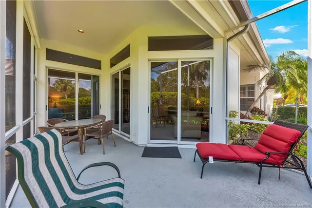 a building outdoor space with patio furniture and glass door