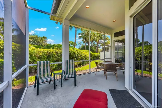 a balcony with furniture and a potted plant