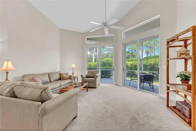 a living room with furniture and large windows