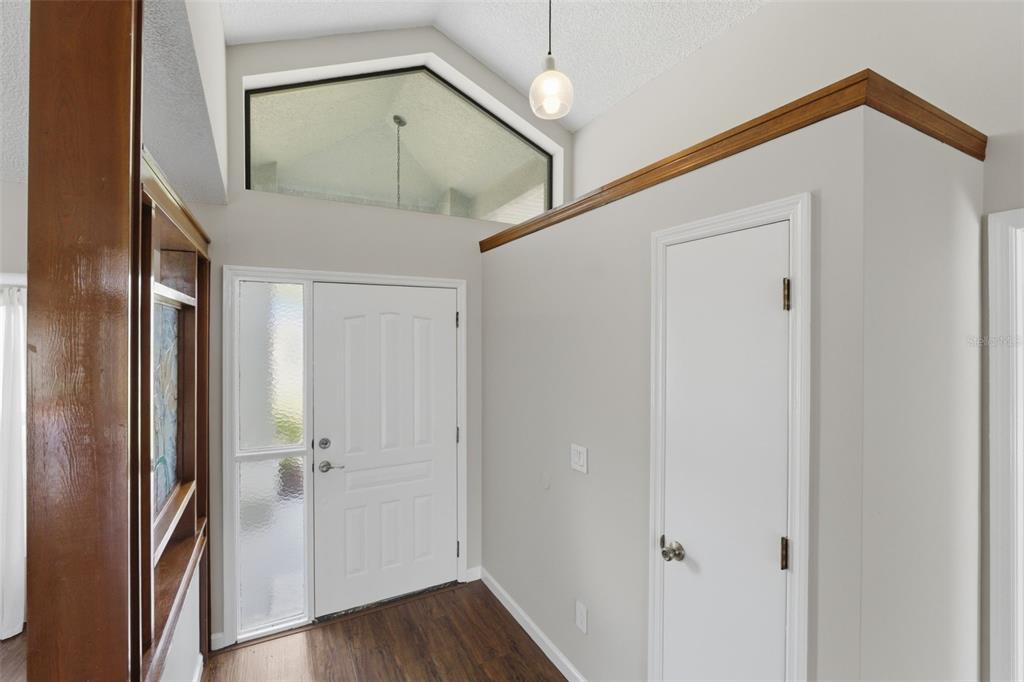 4966 Keysville Avenue Spring Hill, FL 34608 - Photo 6 of 48 a view of a hallway with wooden floor and entryway