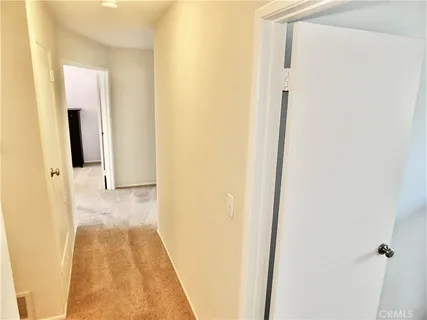 a bedroom with a bed and a dresser next to a window