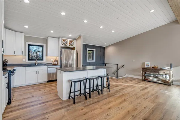 a living room with furniture and a floor to ceiling window