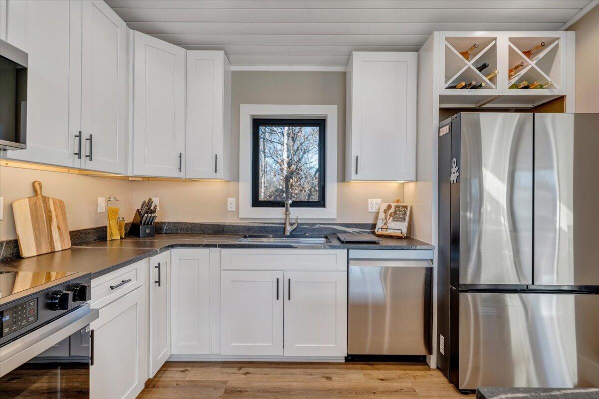 5 Reserve Road Moneta, VA 24121 - Photo 20 of 95 a kitchen with granite countertop a refrigerator a sink and wooden cabinets
