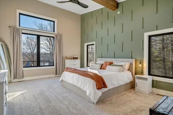 a living room with furniture a flat screen tv and a walk in closet