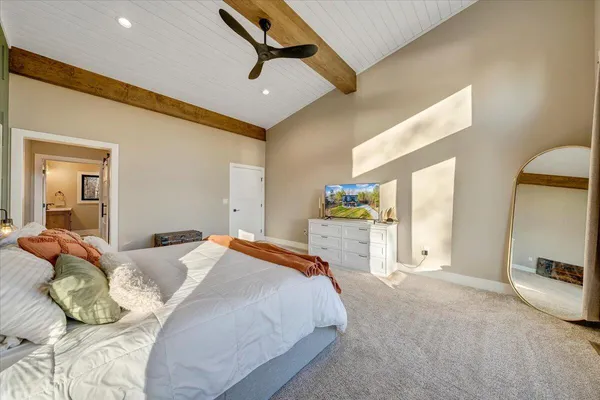 a bedroom with a bed and a night stand