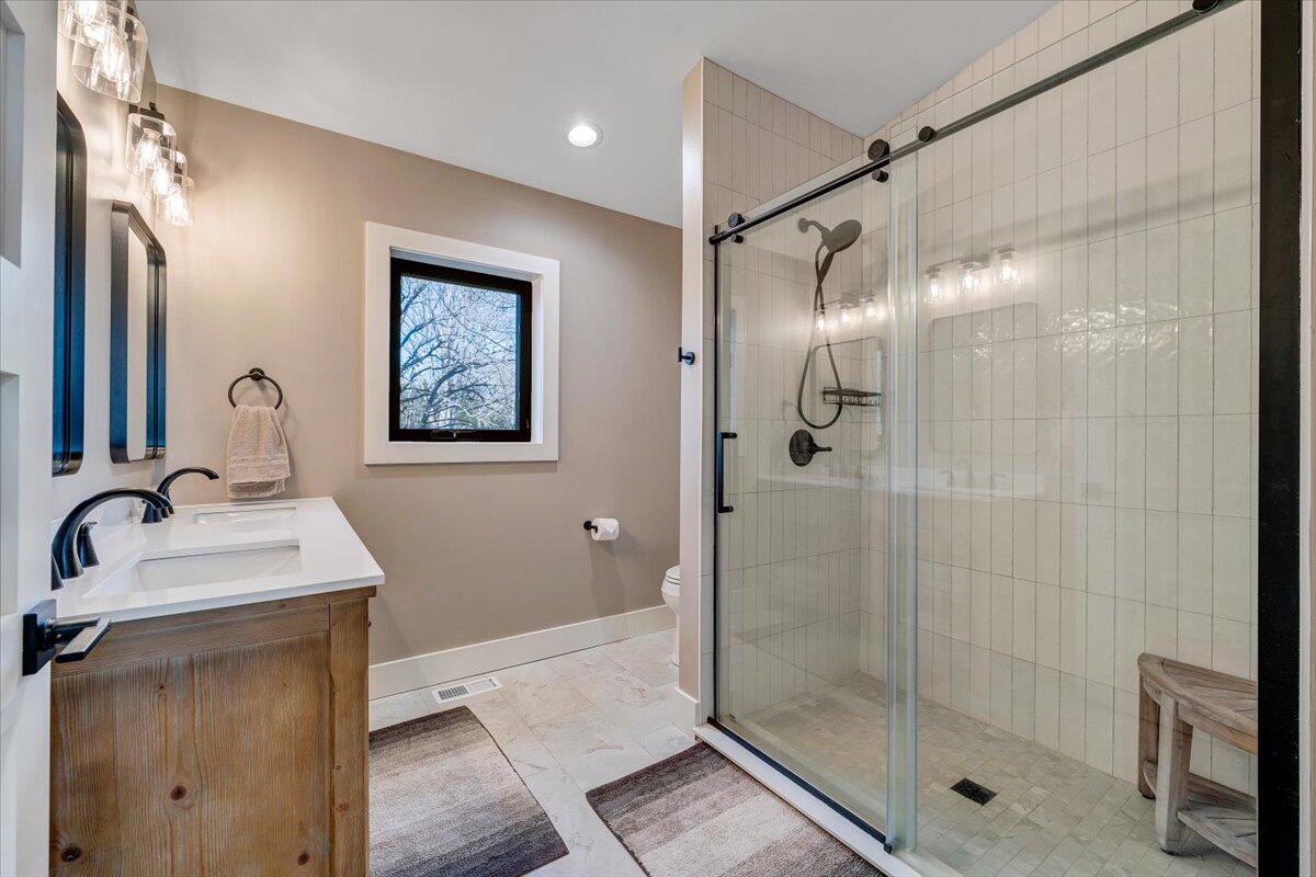 5 Reserve Road Moneta, VA 24121 - Photo 44 of 95 a bathroom with a shower sink and mirror