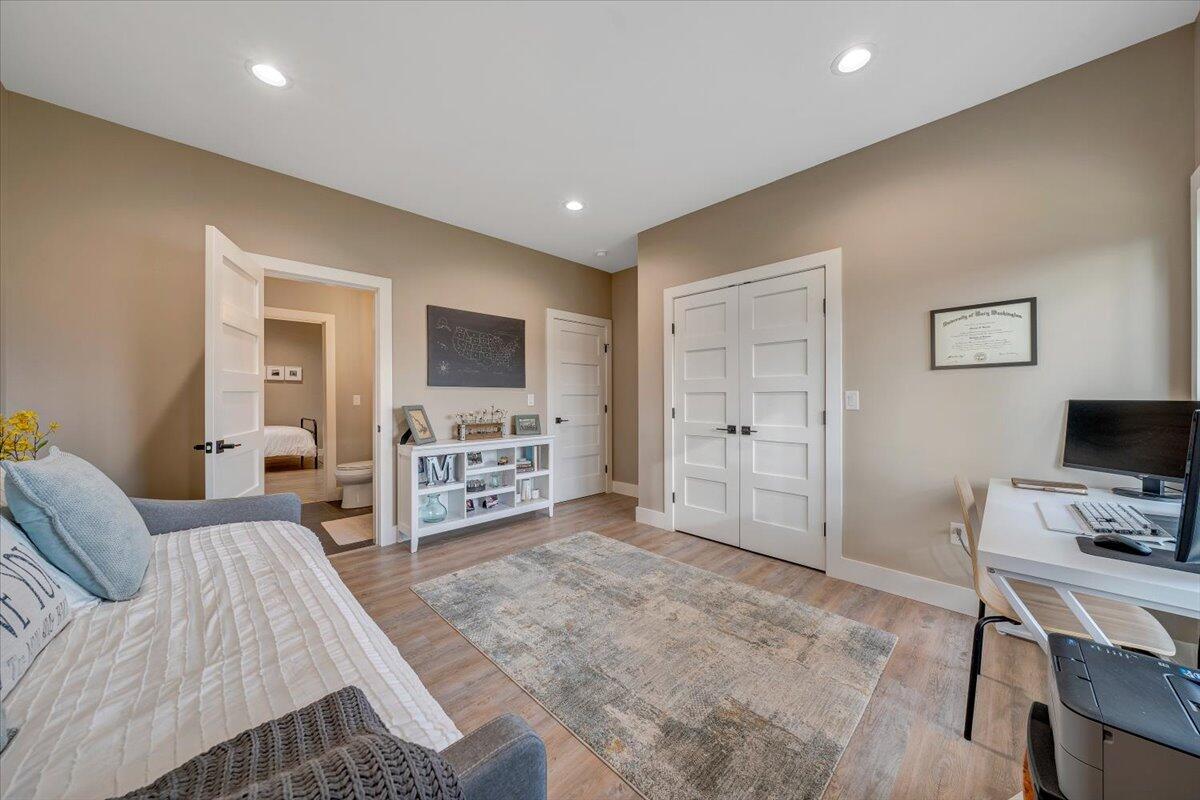 5 Reserve Road Moneta, VA 24121 - Photo 51 of 95 a living room with furniture a flat screen tv and a walk in closet