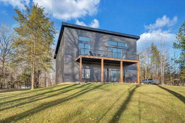 a view of a workspace with furniture and wooden floor