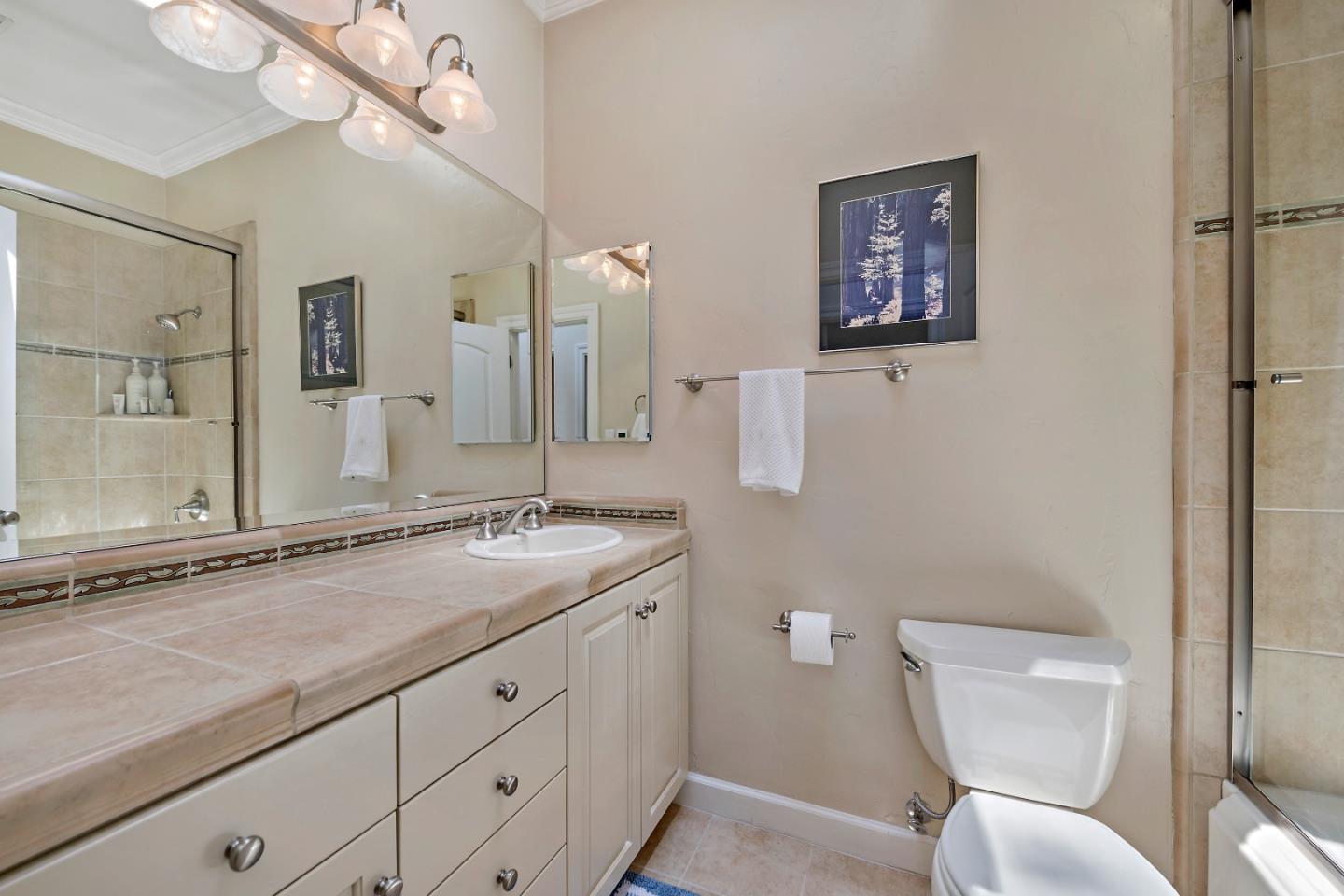 18 Farm Road Los Altos, CA 94024 - Photo 20 of 27 a bathroom with a granite countertop toilet sink and mirror