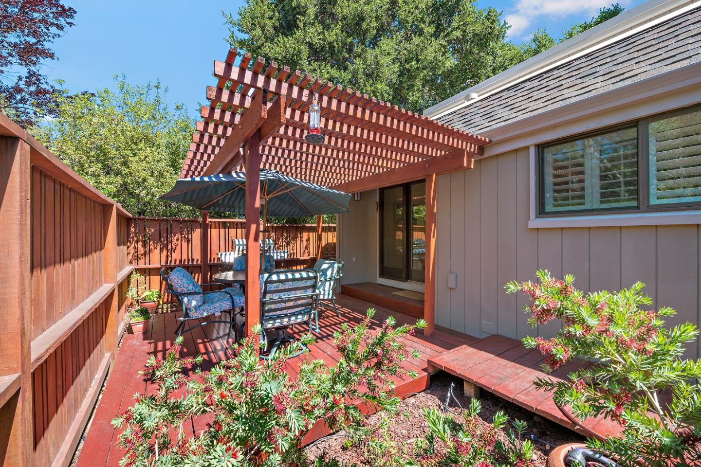 18 Farm Road Los Altos, CA 94024 - Photo 3 of 27 a patio with table and chairs and potted plants