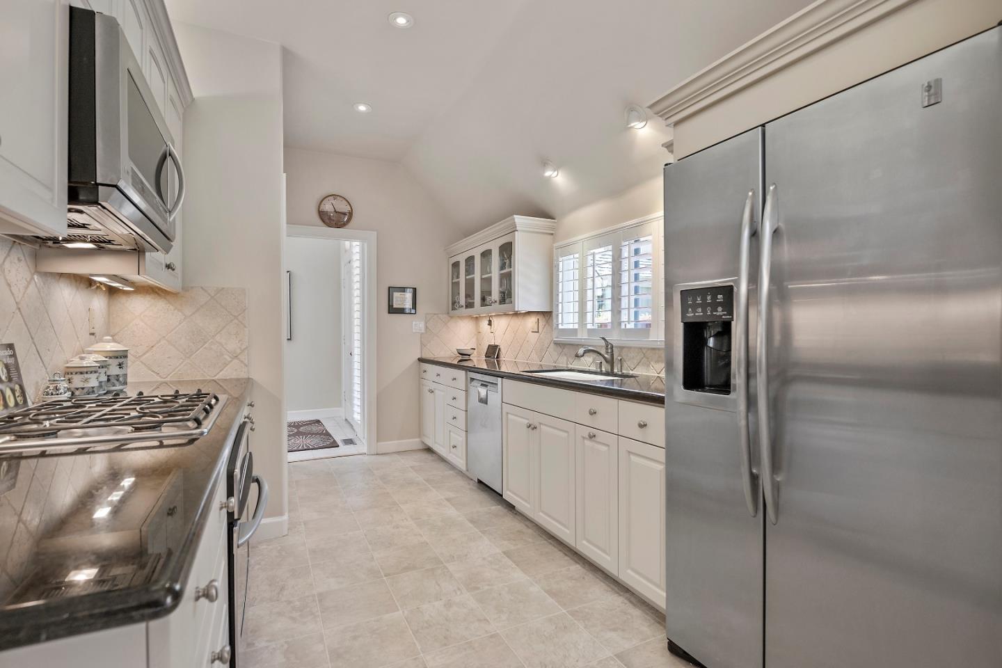 18 Farm Road Los Altos, CA 94024 - Photo 6 of 27 a kitchen with stainless steel appliances granite countertop a refrigerator a sink a stove and white cabinets
