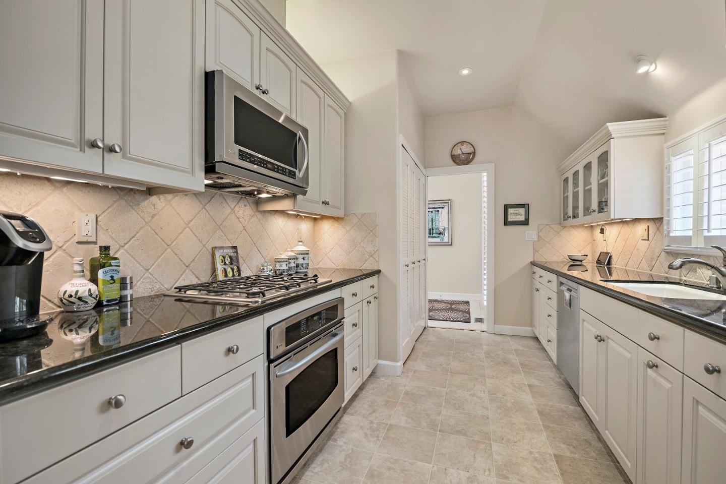 18 Farm Road Los Altos, CA 94024 - Photo 7 of 27 a kitchen with stainless steel appliances granite countertop a sink and a stove