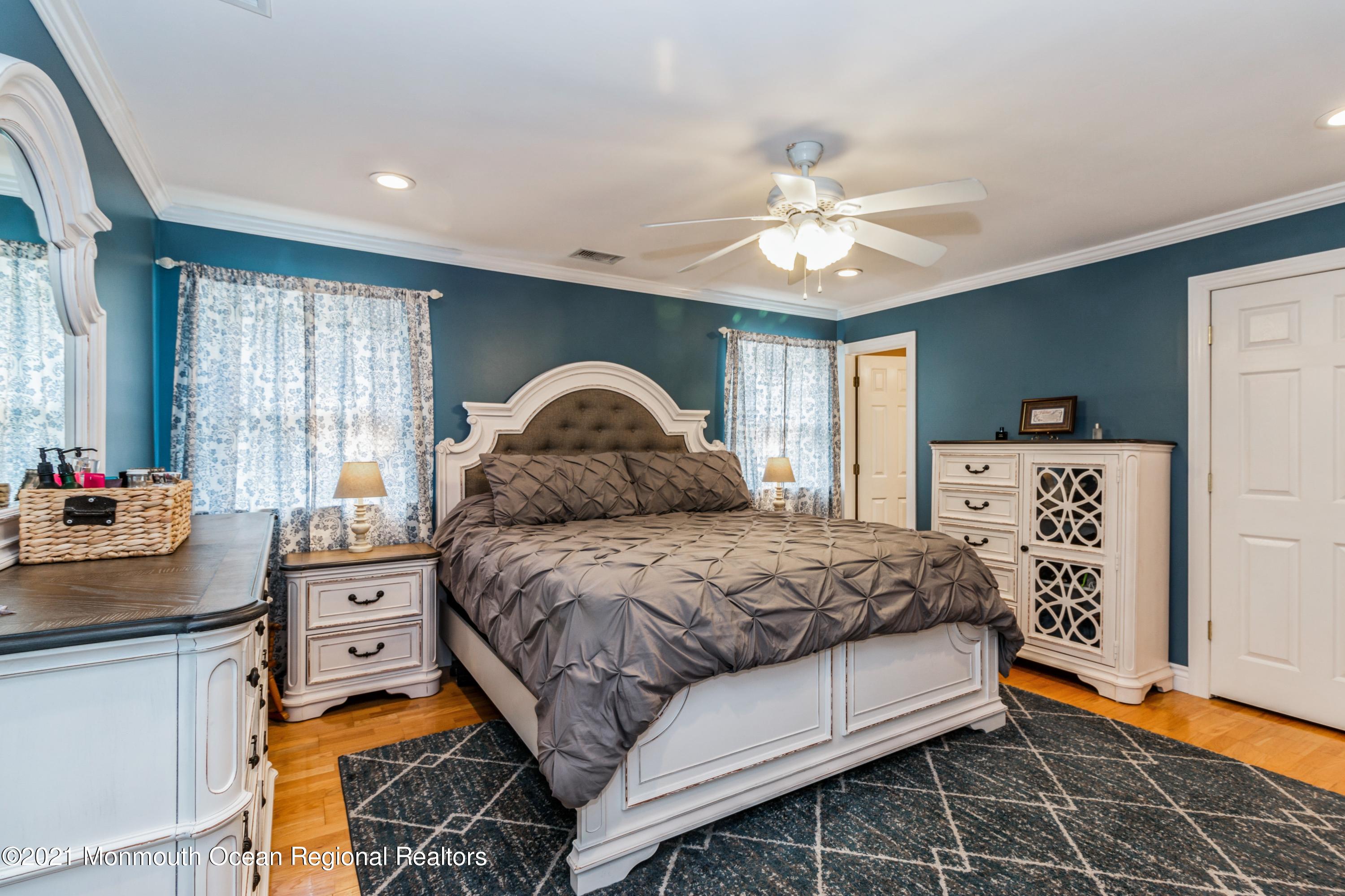 258 Sunnybrook Road Jackson, NJ 08527 - Photo 11 of 20 a bedroom with a bed and a chandelier
