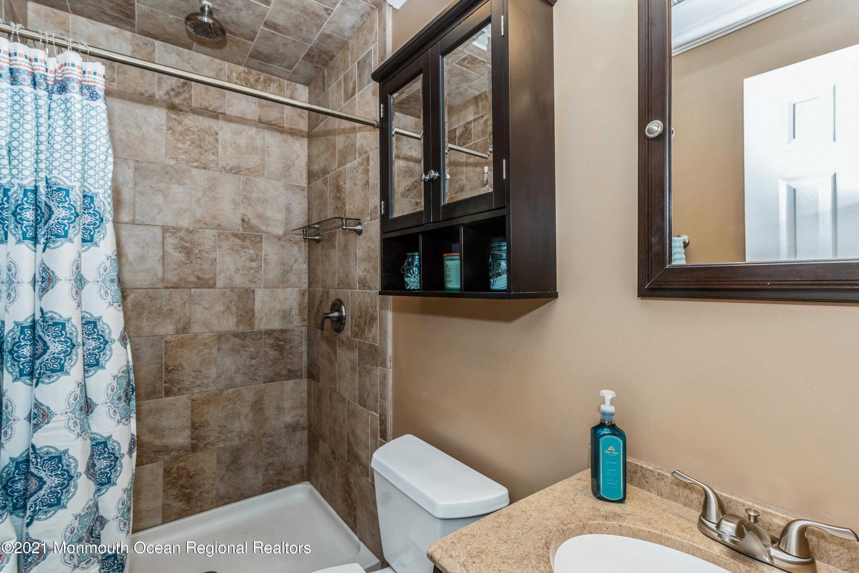 258 Sunnybrook Road Jackson, NJ 08527 - Photo 12 of 20 a bathroom with a sink a toilet and shower