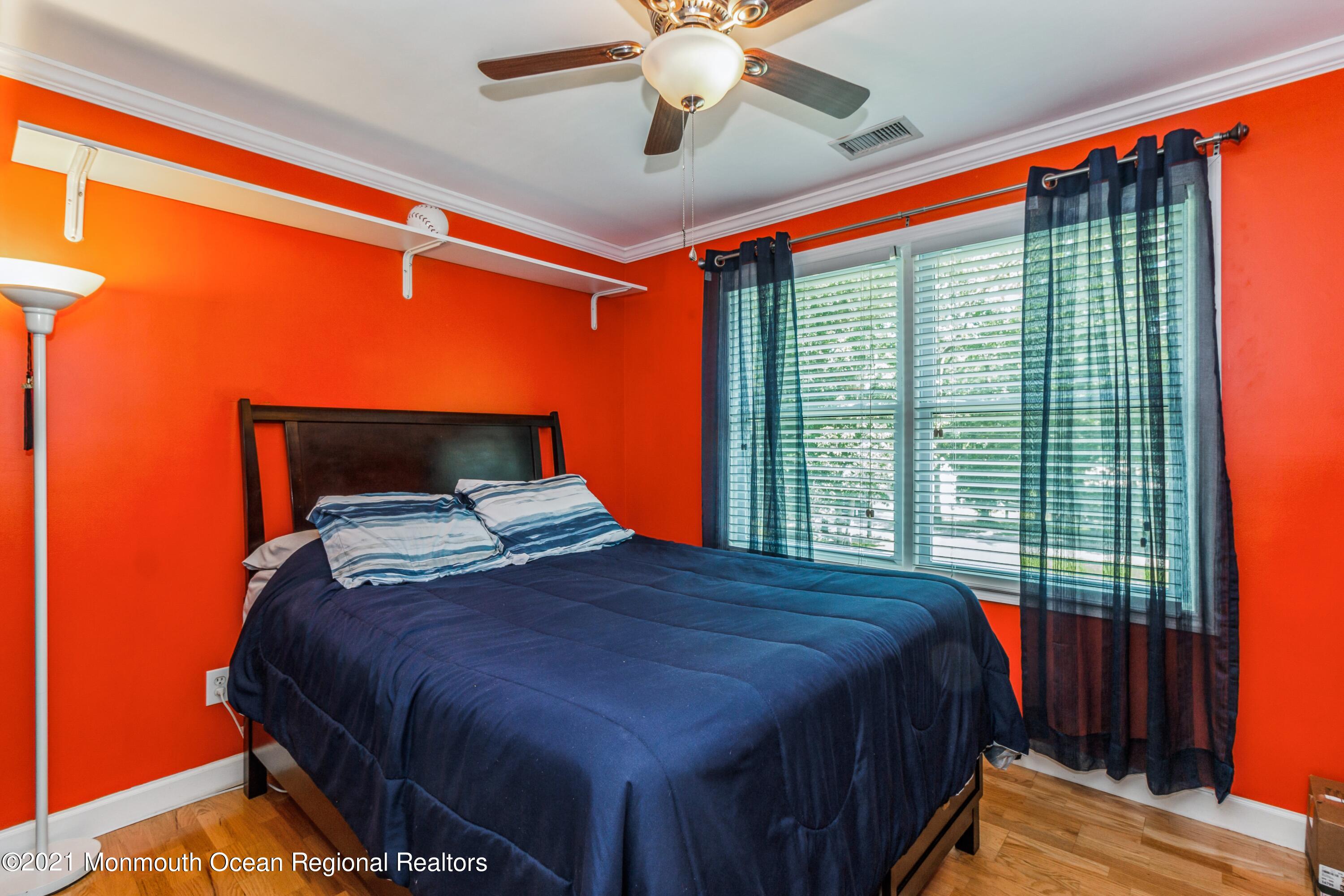 258 Sunnybrook Road Jackson, NJ 08527 - Photo 14 of 20 a bedroom with a bed and a chandelier