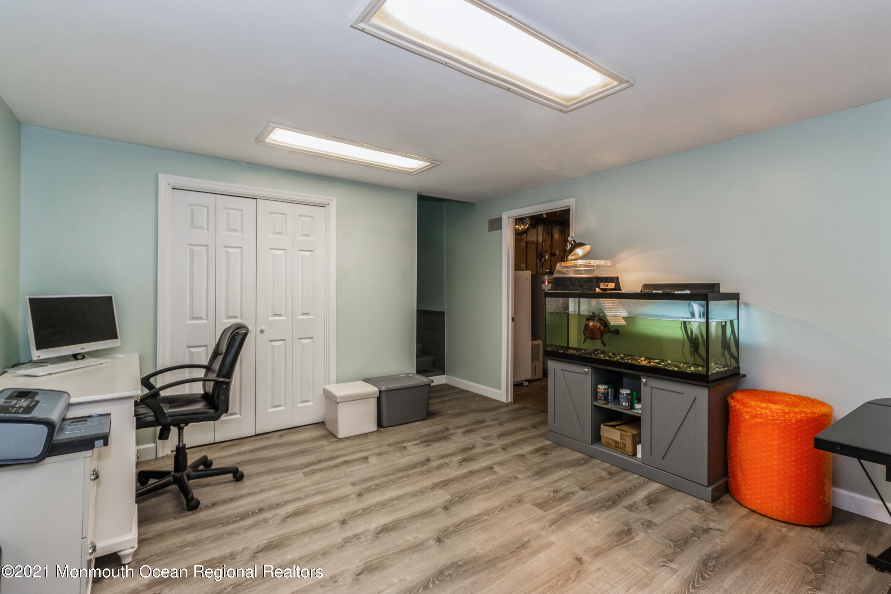258 Sunnybrook Road Jackson, NJ 08527 - Photo 16 of 20 a view of a workspace with furniture and a flat screen tv