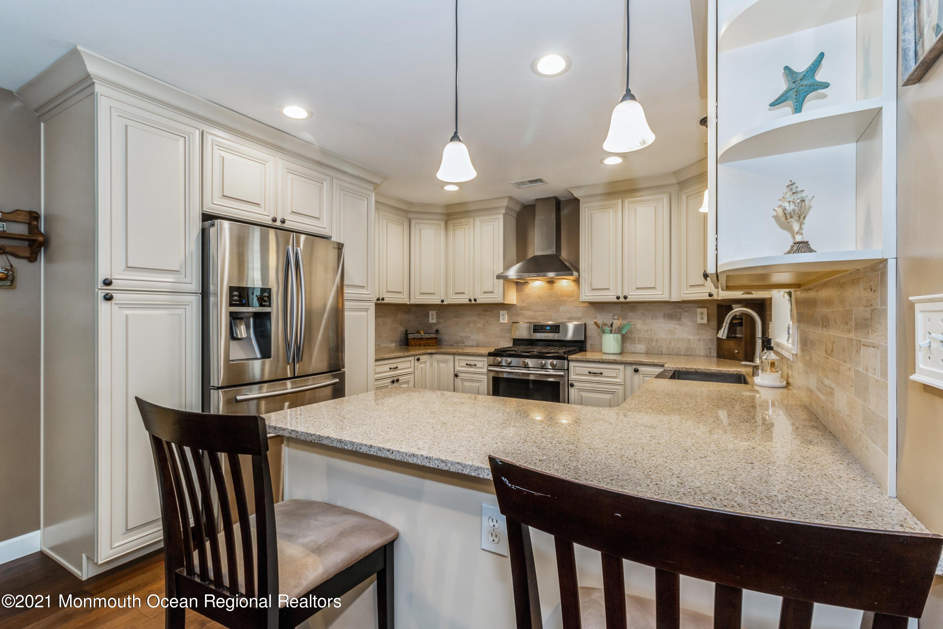 258 Sunnybrook Road Jackson, NJ 08527 - Photo 5 of 20 a kitchen with refrigerator cabinets dining table and chairs