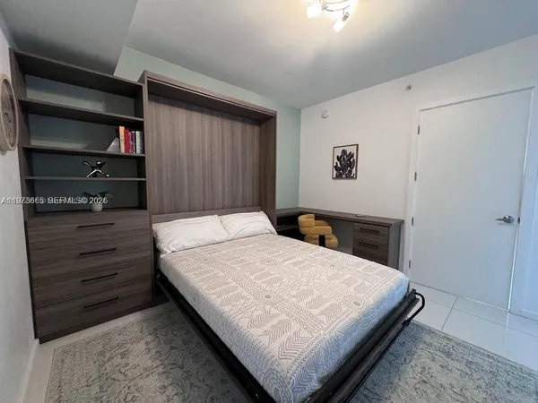 a bedroom with a bed and a cabinets