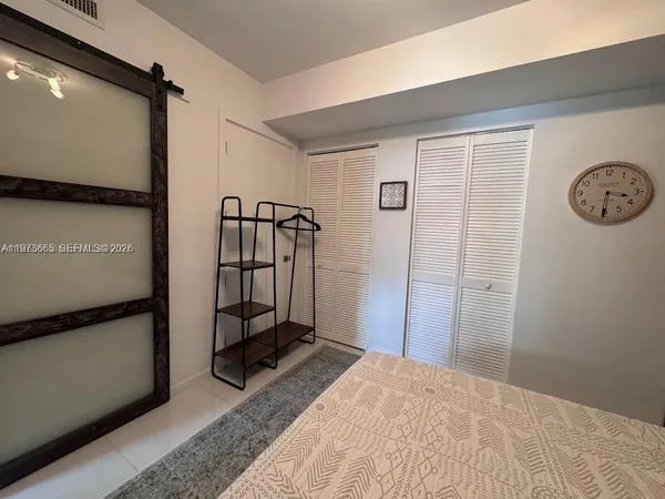 a bedroom with a bed and a mirror