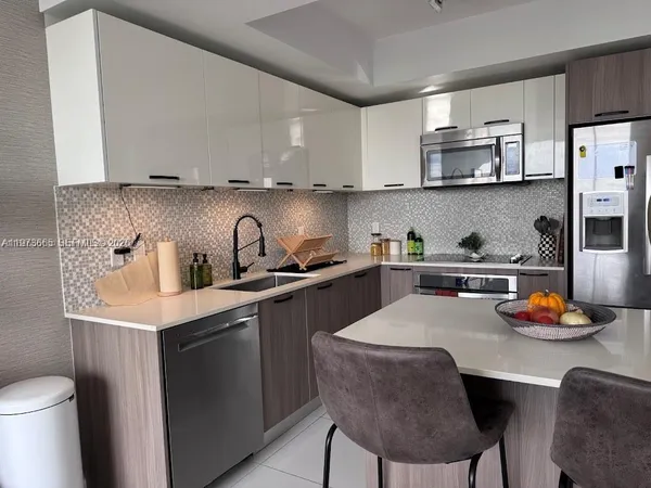 a kitchen with a sink a stove and cabinets