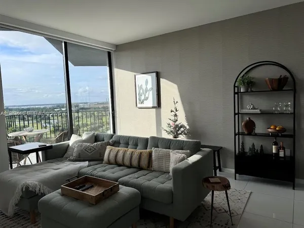 a living room with furniture and a large window