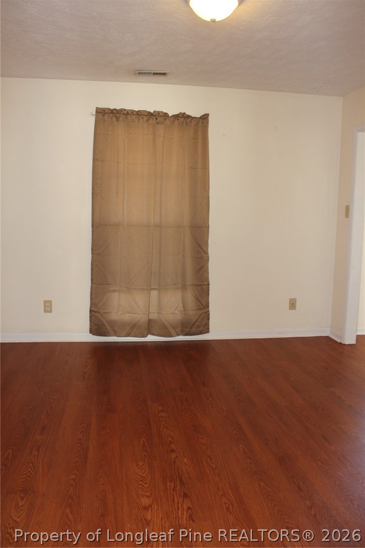 7805 Gallant Ridge Drive Fayetteville, NC 28314 - Photo 2 of 25 an empty room with wooden floor and closet