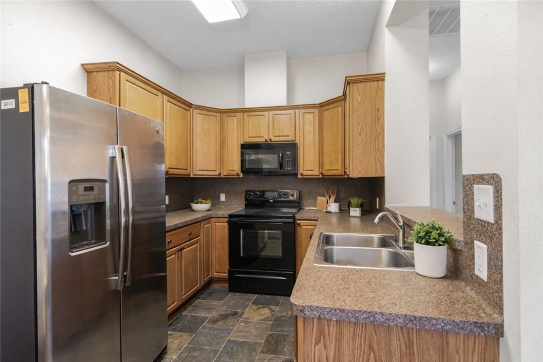 1002 Copperas Bend Caldwell, TX 77836 - Photo 4 of 22 a kitchen with stainless steel appliances granite countertop a refrigerator a stove top oven a sink and dishwasher