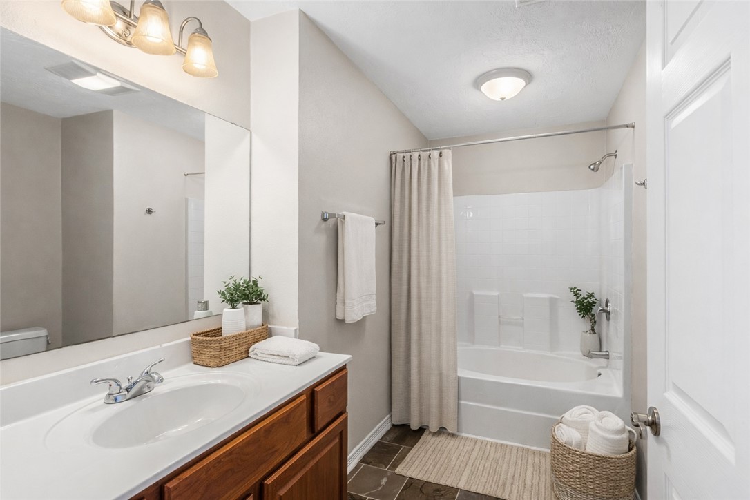 1002 Copperas Bend Caldwell, TX 77836 - Photo 7 of 22 a bathroom with a granite countertop sink toilet and shower