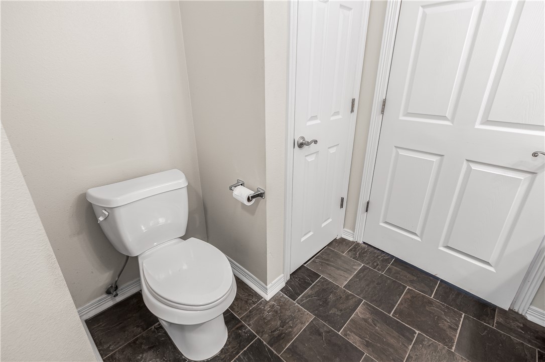 1002 Copperas Bend Caldwell, TX 77836 - Photo 8 of 22 a white toilet sitting next to a sink