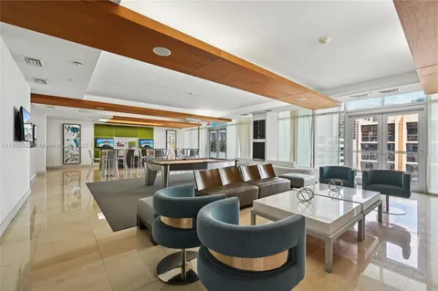 a living room with patio furniture and a large window