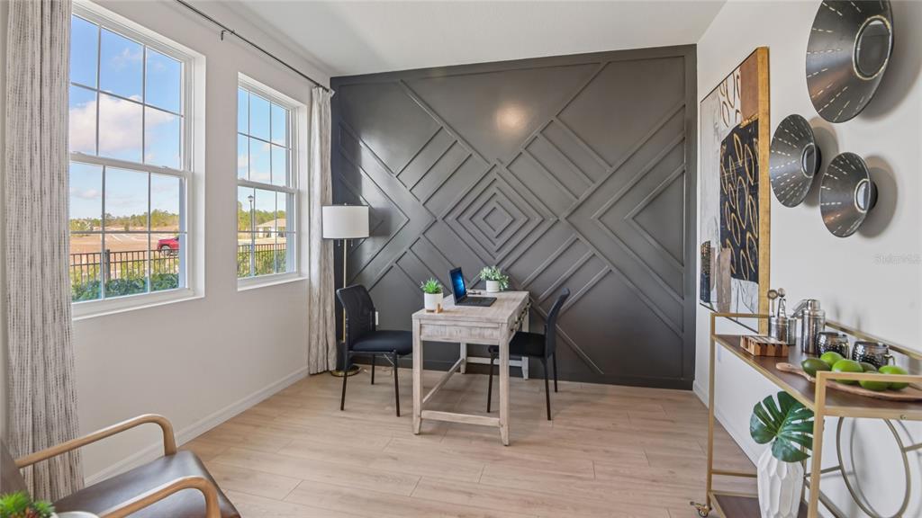 11238 Duckling Way Weeki Wachee, FL 34613 - Photo 12 of 30 a workspace with furniture and wooden floor
