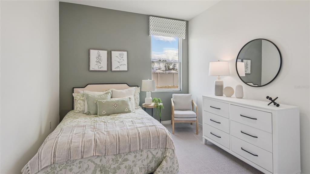 11238 Duckling Way Weeki Wachee, FL 34613 - Photo 13 of 30 a bedroom with a bed a mirror and a table