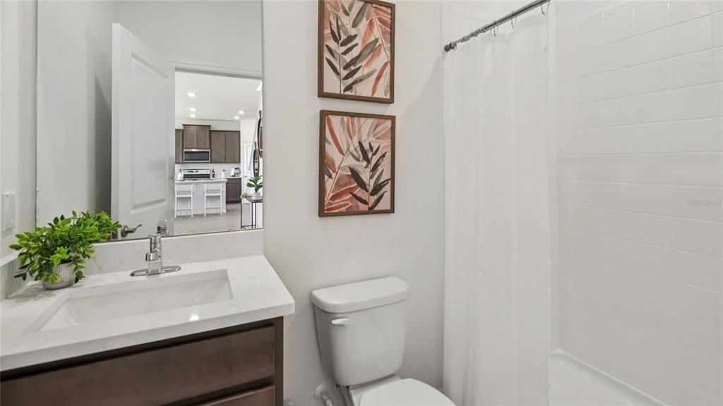 11238 Duckling Way Weeki Wachee, FL 34613 - Photo 14 of 30 a bathroom with a sink a toilet and a mirror