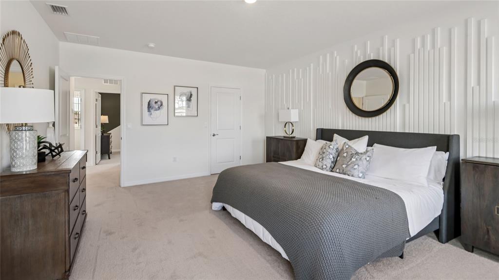 11238 Duckling Way Weeki Wachee, FL 34613 - Photo 19 of 30 a bedroom with a bed and a chandelier