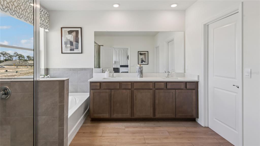 11238 Duckling Way Weeki Wachee, FL 34613 - Photo 20 of 30 a bathroom with a double vanity sink and a mirror