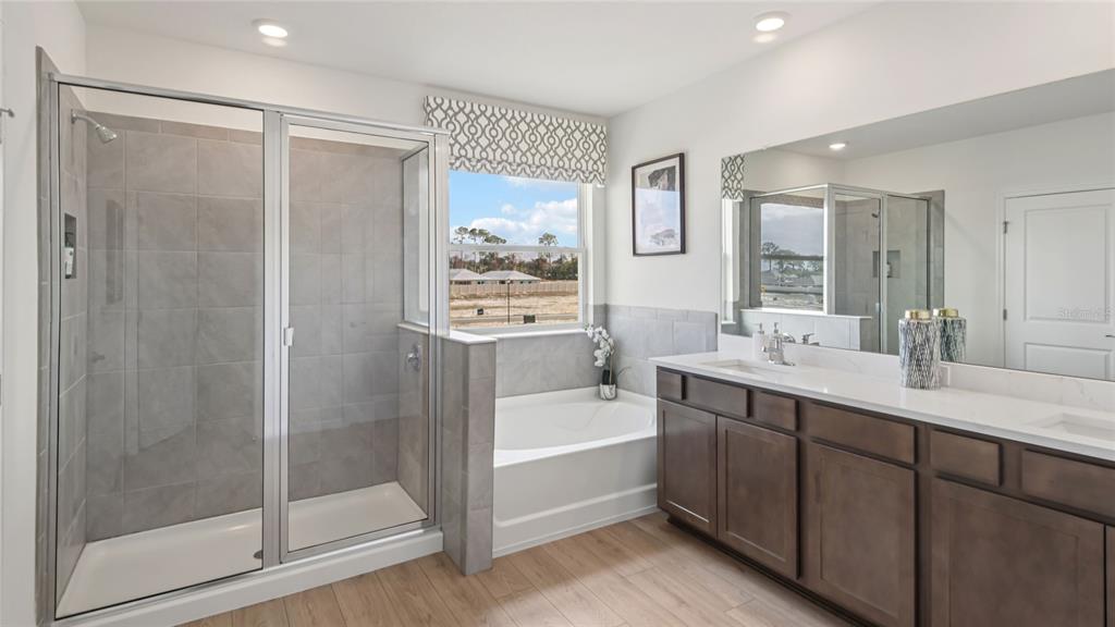 11238 Duckling Way Weeki Wachee, FL 34613 - Photo 21 of 30 a bathroom with a tub sink shower and mirror
