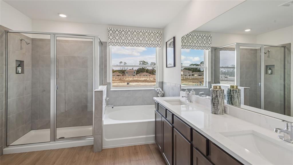 11238 Duckling Way Weeki Wachee, FL 34613 - Photo 22 of 30 a bathroom with a tub sink shower and mirror