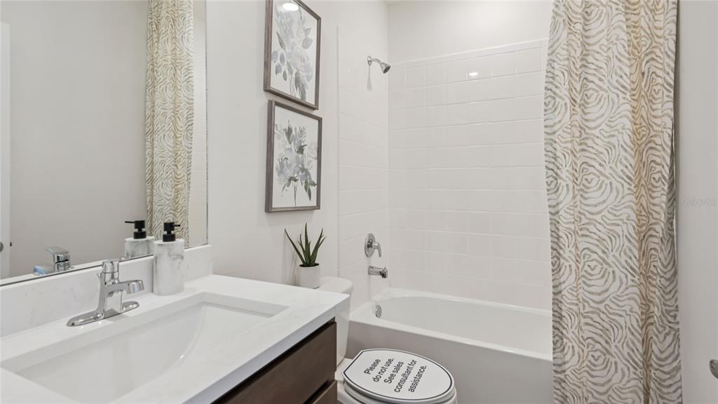11238 Duckling Way Weeki Wachee, FL 34613 - Photo 25 of 30 a bathroom with a sink a mirror a bathtub and shower