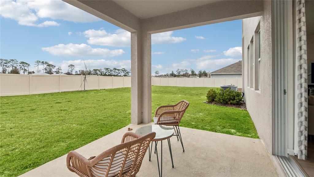 11238 Duckling Way Weeki Wachee, FL 34613 - Photo 27 of 30 a view of a chair and table in backyard of the house