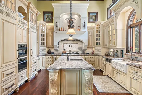 a dining room with furniture large windows and a chandelier
