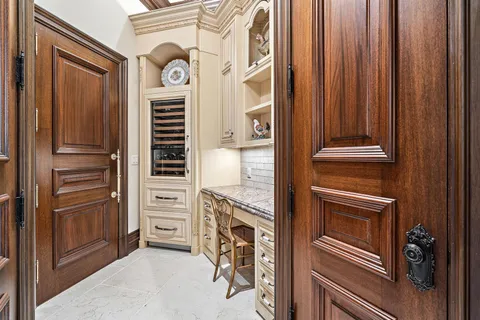 a living room with furniture a fireplace and a chandelier