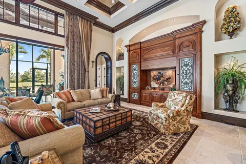 a living room with furniture a fireplace and a table