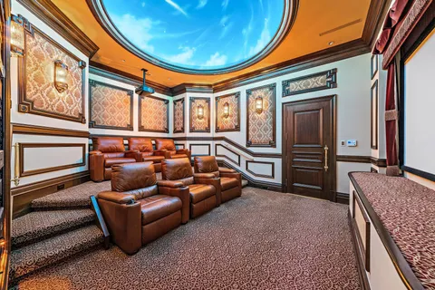 a living room with a large window and furniture