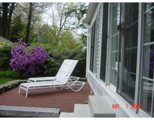 161 Woodcliff Road Newton, MA 02461 - Photo 9 of 30 a view of a chairs and table in the back yard of the house