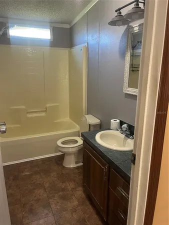 a bathroom with a toilet a sink and bathtub