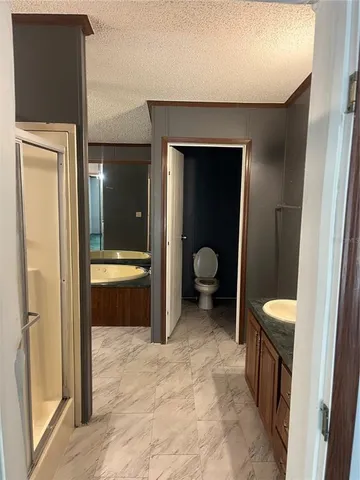 a spacious bathroom with a toilet and a sink