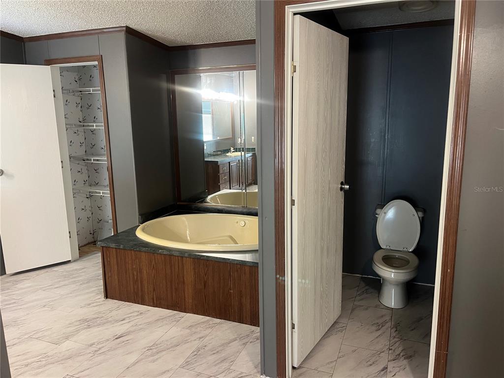 1145 Yaun Road Southeast Moore Haven, FL 33471 - Photo 24 of 26 a bathroom with a sink and a mirror