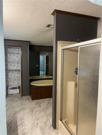 a bathroom with a tub and shower
