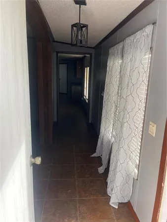 a hallway with windows and flowers