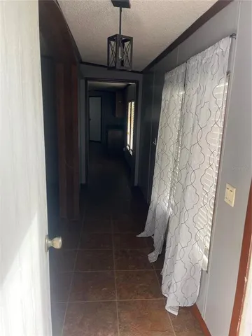 a hallway with windows and flowers